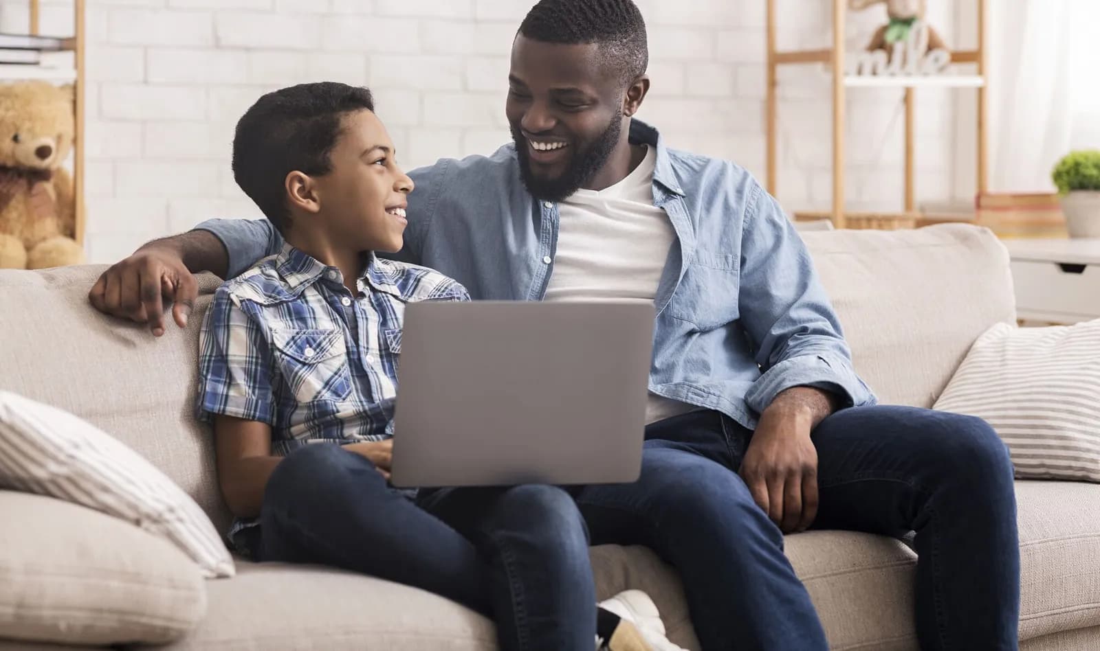 smiling dad and son looking at each other